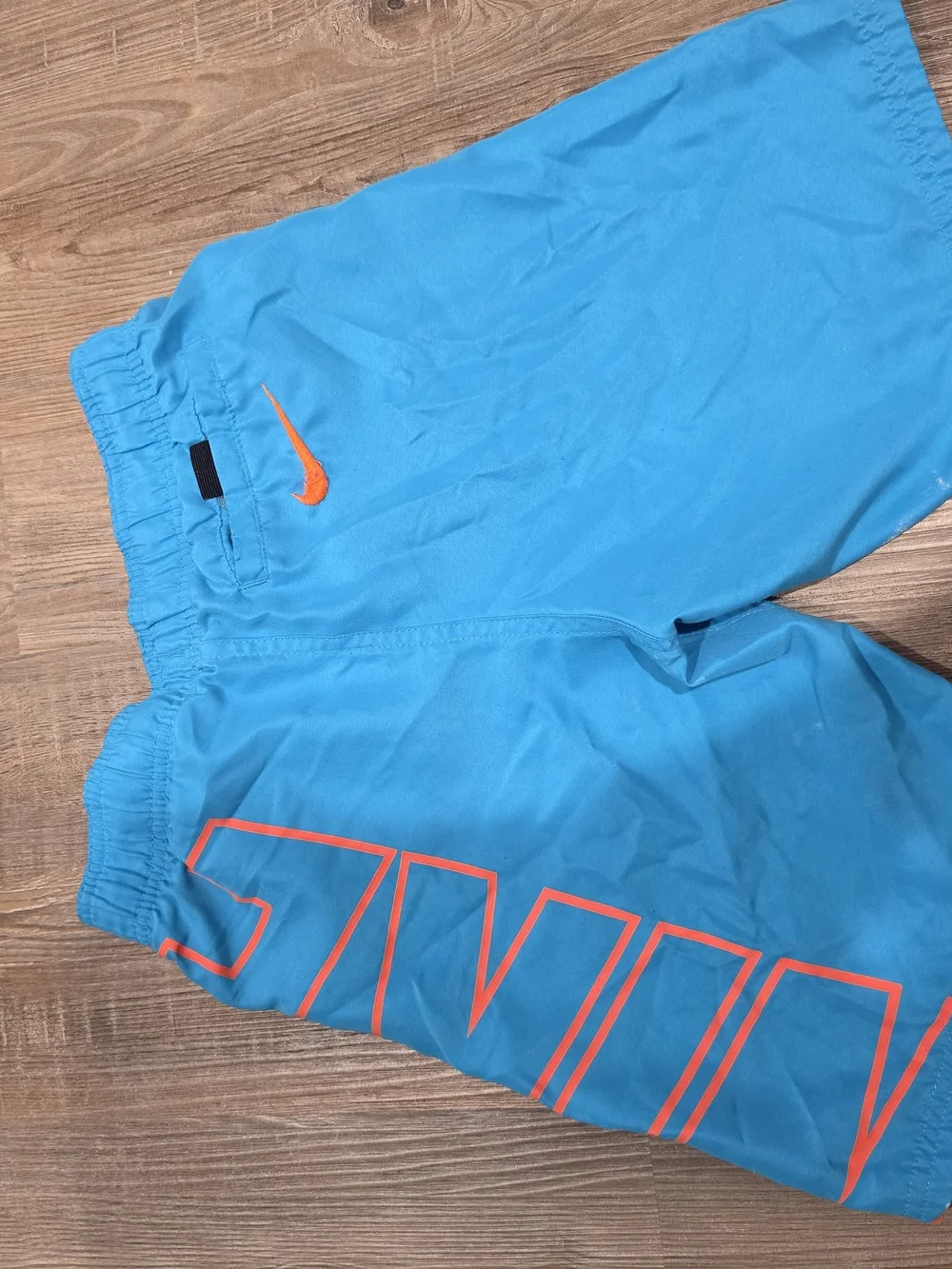 Nike Kids Blue Swim Trunks with Orange Accents